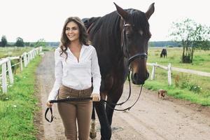 Young woman rider and her beautiful horse photo