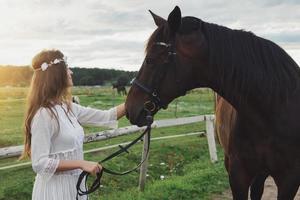 Cute young woman and her beautiful horse photo