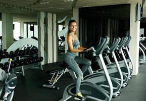 Woman on stationary bike in the gym photo