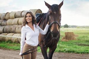 Young woman rider and her beautiful horse photo