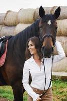 Young woman rider and her beautiful horse photo