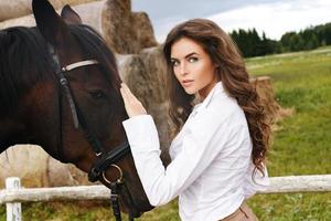 Young woman rider and her beautiful horse photo