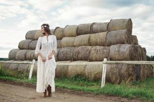 Woman wearing stylish white dress in the country side photo
