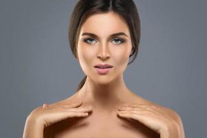 retrato de belleza de una joven mujer encantadora de fondo gris foto