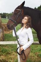 Young woman rider and her beautiful horse photo