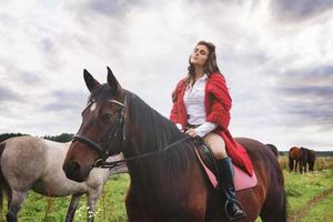 Young woman rider and her beautiful horse photo