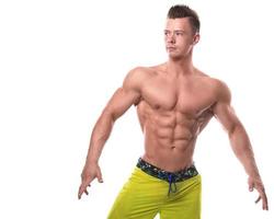 Fitness model in green shorts over white background photo