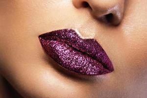 Close up of female lips with shining glitters photo