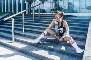 Stylish girl with a skateboard onstreet photo