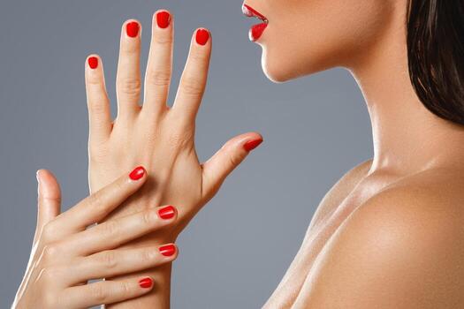 Beauty and cosmetics. Female mouth and nails with red manicure and lipstick. photo