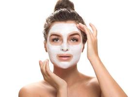 Woman with facial mask on white background photo