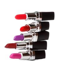 Lipsticks tubes of different colors on white background photo