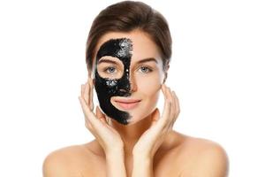 Beautiful woman with a purifying black mask on her face photo