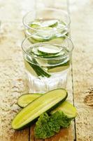 Detox water with cucumber on wooden table photo