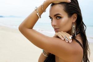 Woman wearing silver jewelry on the beach photo