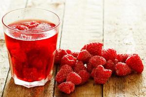 Refreshing drink with raspberry on wooden table photo