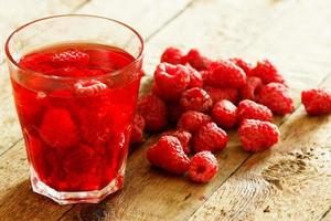 Refreshing drink with raspberry on wooden table photo