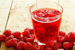 Refreshing drink with raspberry on wooden table photo