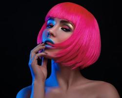 Potrait of young woman with pink hair photo