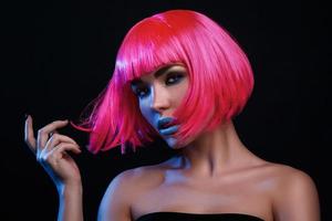 Potrait of young woman with pink hair photo