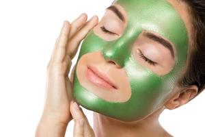 Woman with green peel-off mask on her face photo