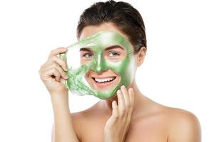 Woman with green peel-off mask on her face photo