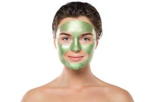 Woman with green peel-off mask on her face photo