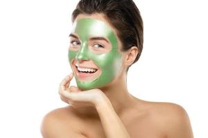 Woman with green peel-off mask on her face photo