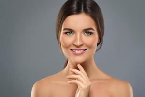 Beauty portrait of young lovely woman on gray photo