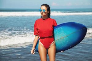 Sexy woman surfer with shortboard on the beach photo