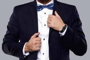 Man in navy blue suit with bow tie photo