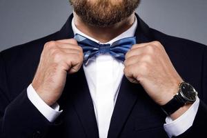 Man is fiting up a beautiful bow tie photo