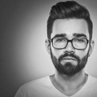 Close up of bearded man in eyeglasses photo