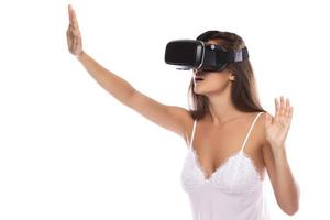 Woman using VR headset on white background photo