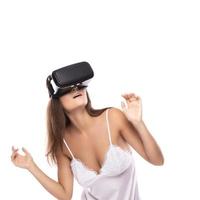 Woman using VR headset on white background photo
