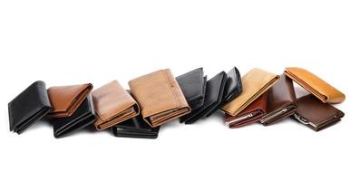 Stack of different wallets on white background photo