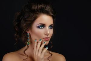 Woung woman wearing beautiful earrings with gemstones photo