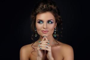 Woung woman wearing beautiful earrings with gemstones photo