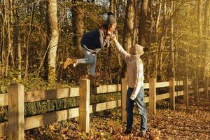 Young couple in the park at sunny autumn day photo