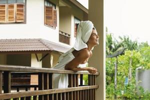 Happy and beautiful woman on the balcony after shower photo