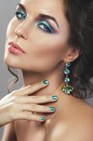 Gorgeous woman wearing beautiful expensive earrings with jewels photo