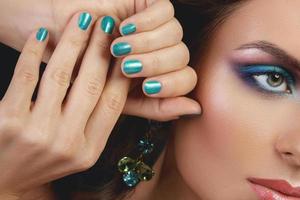 Woman with a beautiful make-up and manicure photo