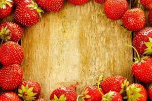 Fresh rustic ripe strawberries on wooden table photo