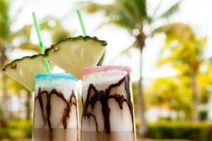 Pina colada cocktail with chocolate syrup photo