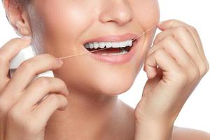 Woman and dental floss on white background photo