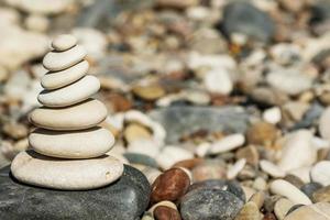 Stack of smooth round stones on pebble beach photo