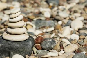 Stack of smooth round stones on pebble beach photo