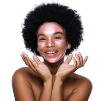 Young African woman with a purifying mask on her face photo