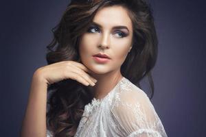 Woman in white dress with beautiful make-up and hairstyle photo