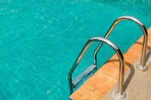 Ladder in the swimming pool with beautiful clean water photo